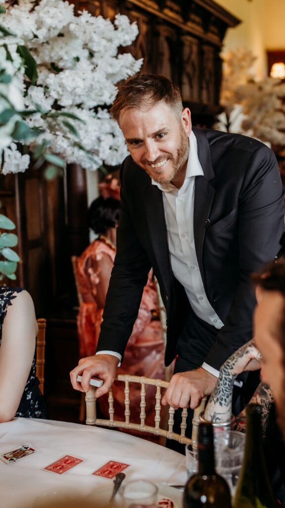 Richard Symes Magic performing a card trick at table