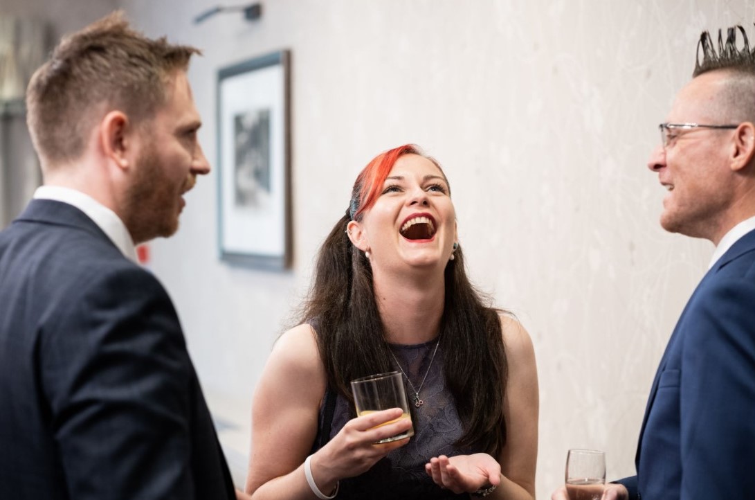 Wedding and events magician Richard Symes performing close-up magic for a crowd of guests, making unforgettable memories