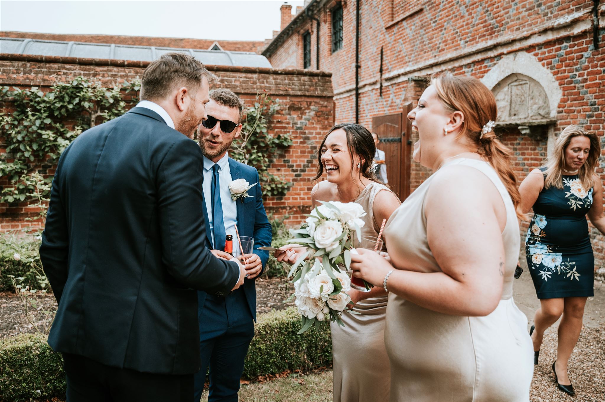 Close-up magician Richard Symes amazing wedding guests with sleight of hand card magic during a UK wedding reception