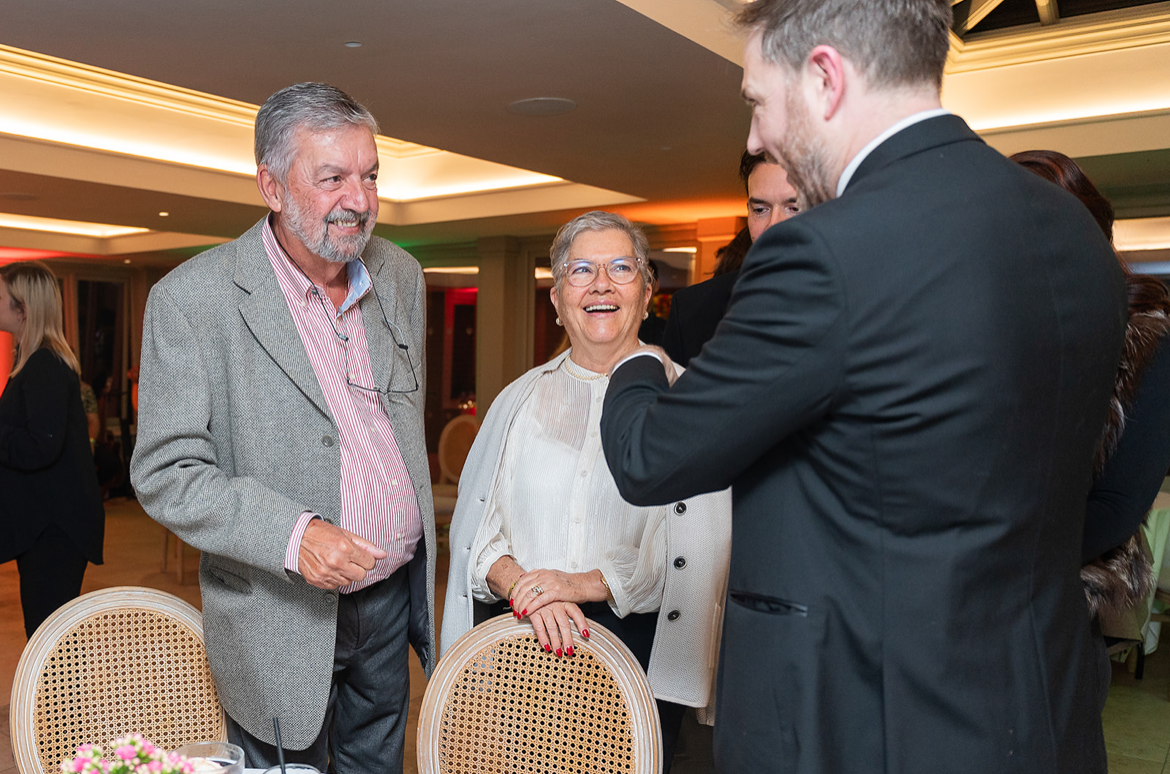 Friends laughing together while watching a magician at a birthday party in Essex