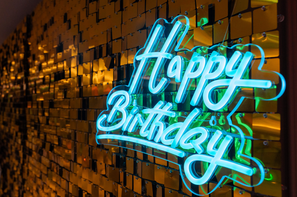 Happy Birthday neon sign glowing at a milestone birthday celebration