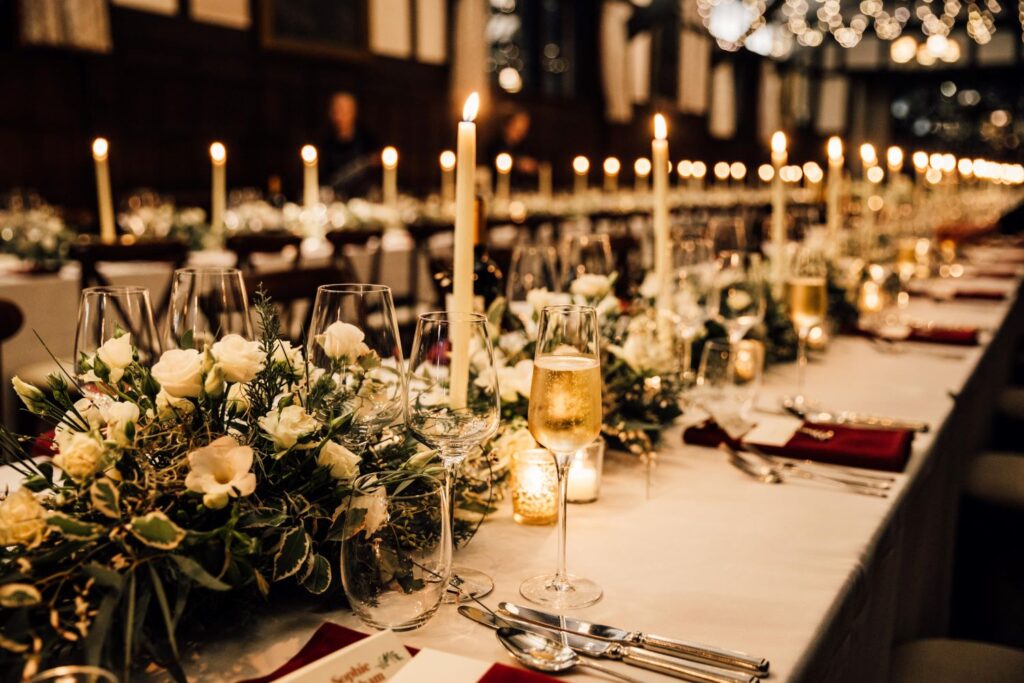 A table set for the party. Candles set up, cutlery on table, high end venue.