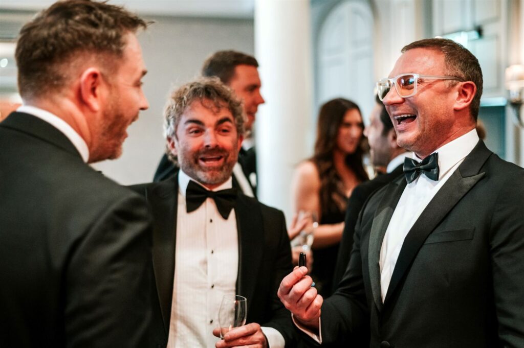 Two corporate guests laughing during close up magic performance