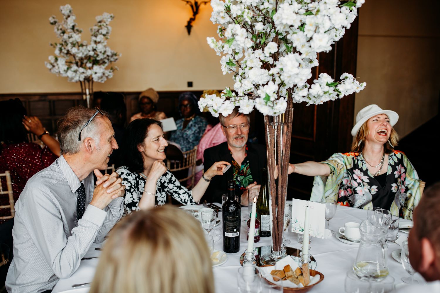 Wedding guests watching table magic with one guest reacting in amazement