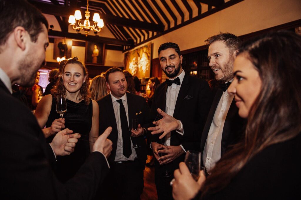 Large group of guests watching an interactive magic performance at a corporate Christmas party