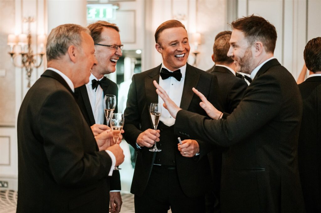 Black tie awards night guests including celebrity husband of Jess Wright enjoying close up magic