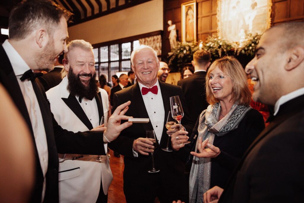 Corporate guests reacting to magic trick at London black tie event