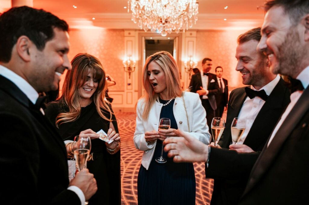 Guest discovering a card in her hand during corporate event magic