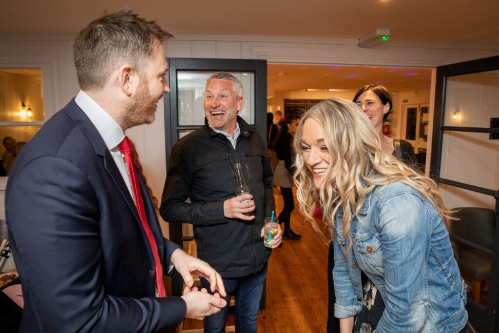 Couple reacting with surprise during close up magic performance