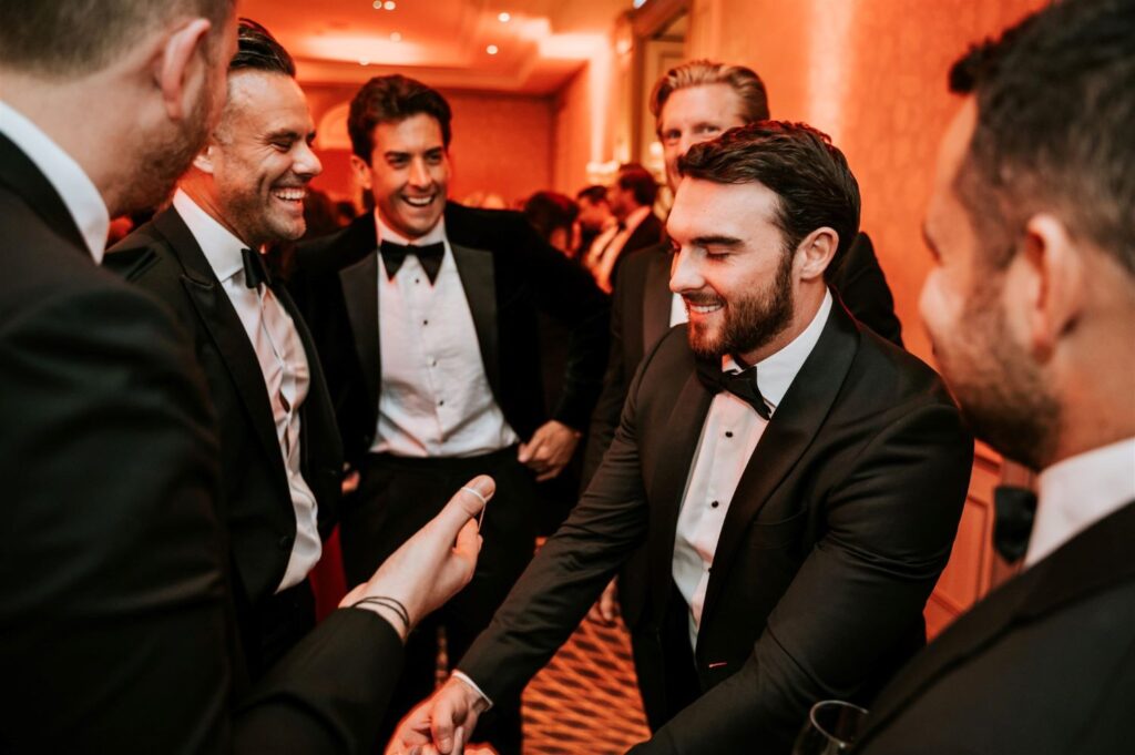 Business guests laughing during close up magic at corporate event