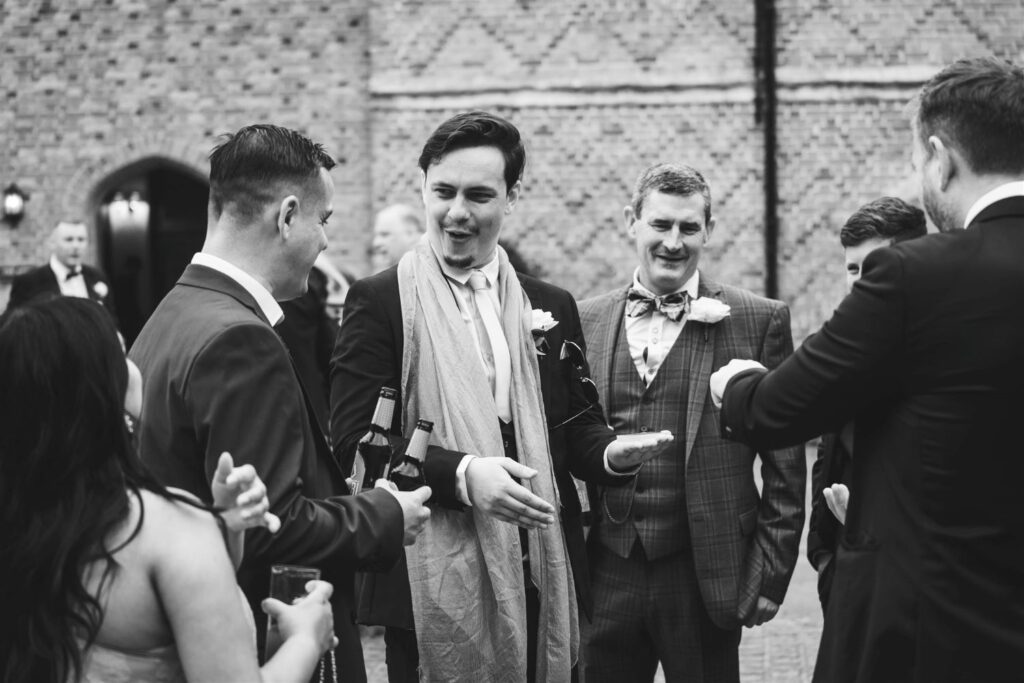 Wedding guests reacting in disbelief to a close up card trick