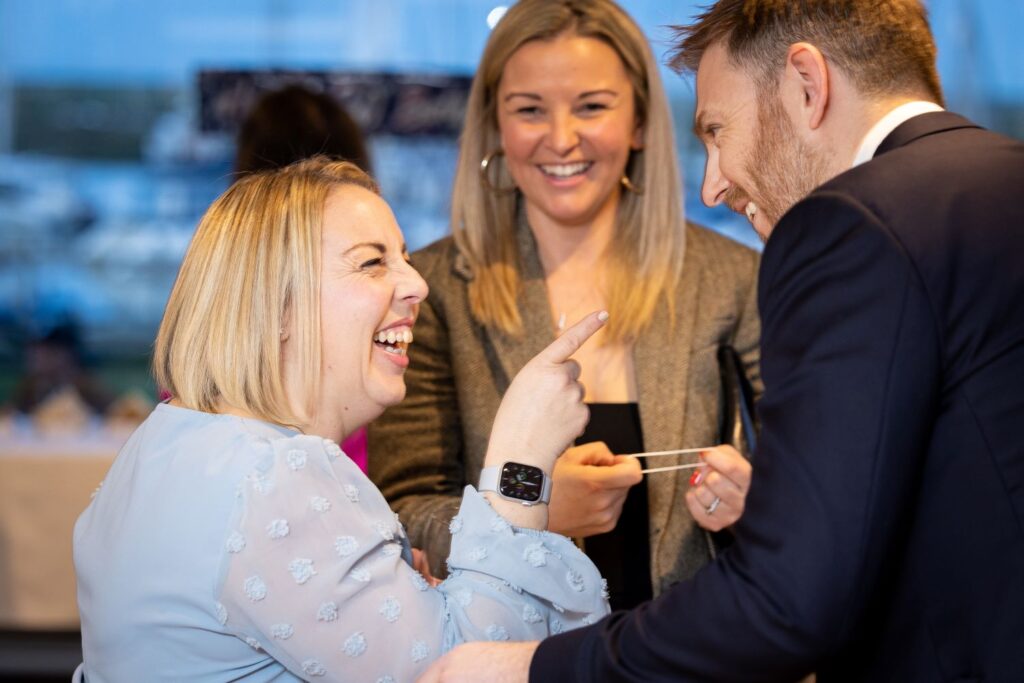 Guest pointing at magician in playful reaction after a trick