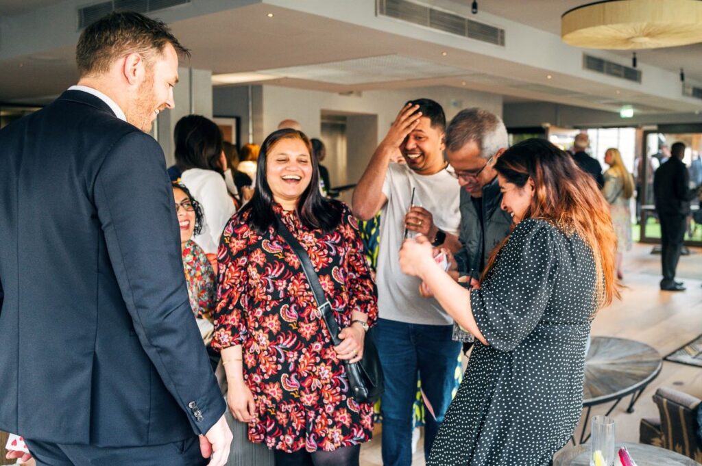 Guests shuffling cards while enjoying birthday party magic