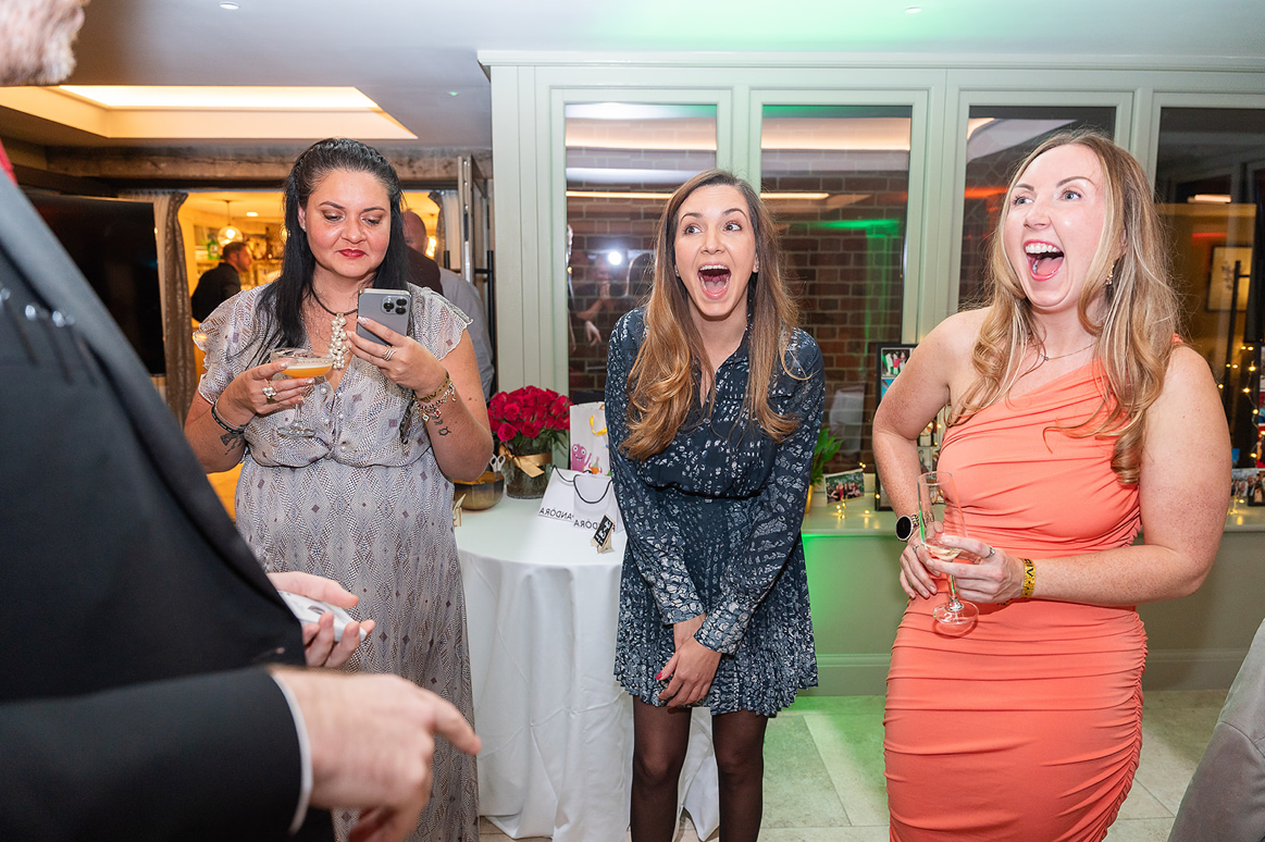 Guests reacting with surprise to interactive magic at Christmas party