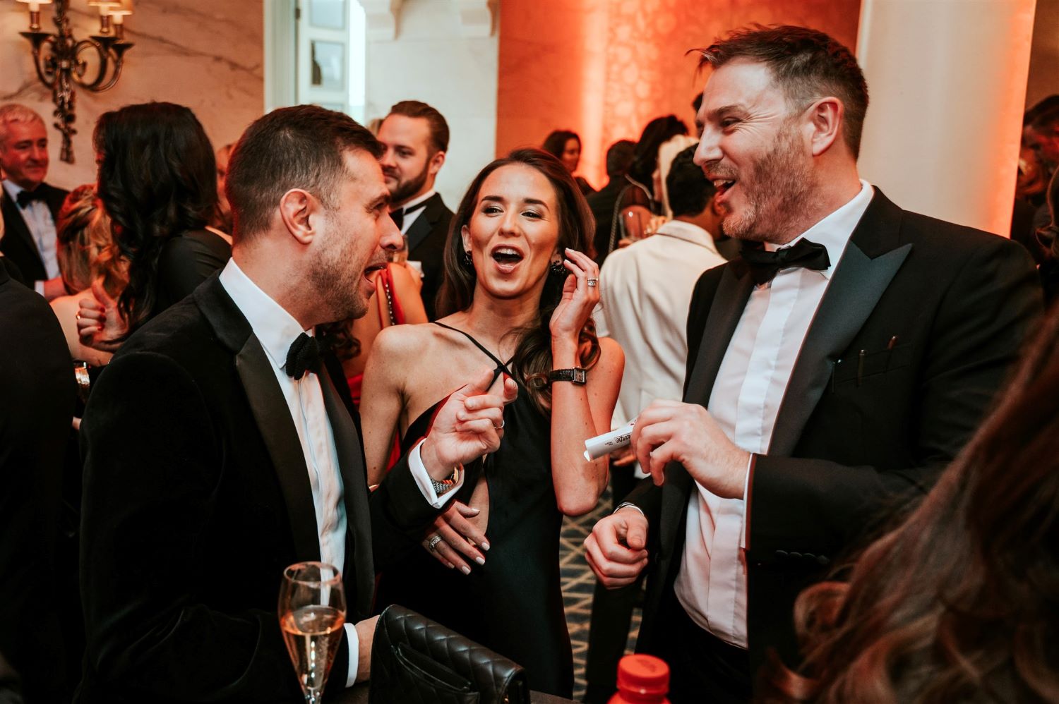 Guests reacting to a card trick at a London awards ceremony in the Savoy